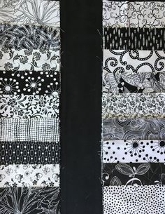 the black and white quilt has many different designs on it