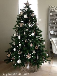 a small christmas tree with ornaments in a basket