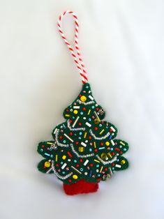 an ornament shaped like a christmas tree with candy canes