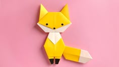 an origami fox on a pink background