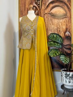 A majestic, exclusive readymade yellow Palazzo/Sharara with heavy embroidered jacket style top. in a beautiful colour.It is stitched and ready to wear. Perfect Indian Party wear, Indo western dress. Details Sharara/Palazzo Fabric: Georgette Inner : Crape lined Design: Plain with Huge Flair Jacket Top Fabric: Georgette Inner : Crape lined Design: Sleeveless v neck with heavy embroidery with stylish buttons on the front Dupatta Fabric : Georgette Design : Designer dupatta with lace edging on all f Yellow Sets With Gota Work For Transitional Season, Yellow Sets With Gota Work For Seasonal Transition, Transitional Yellow Sets With Gota Work, Yellow Unstitched Sharara For Transitional Season, Elegant Yellow Palazzo Set With Traditional Drape, Yellow Semi-stitched Sharara For Transitional Season, Elegant Yellow Palazzo Set For Eid, Yellow Anarkali Set With Dabka Work For Transitional Season, Transitional Yellow Anarkali Set With Dabka Work