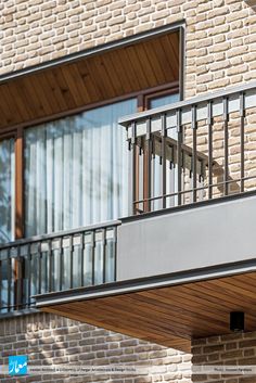 a balcony on the side of a brick building