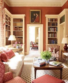 a living room filled with furniture and bookshelves