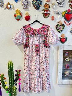 Our San Antonino dresses are unique, beautiful and perfect for any fiesta, a day at the beach or a formal event. You can easily dress it up or dress it down. Our dresses are completely hand embroidered by Artisans in Oaxaca, Mexico. It takes approximately 1 month to complete one dress.  Our San Antonino dresses are one of a kind. You will fall in love with every single detail. Each dress is hand embroidered on front chest area, sides and back with tiny floral designs inspired by the flowers in t Pink Embroidered Ruffle Dress For Summer, Pink Embroidered Ruffles Dress For Summer, Pink Embroidered Dress With Ruffles For Summer, Pink Ruffled Dress For Festival, Multicolor Ruffled Dresses For Festival, Festival Floral Print Short Sleeve Dresses, Multicolor Ruffled Festival Dress, Embroidered Short Sleeve Dress For Garden Party, Embroidered Dresses For Spring Fiesta