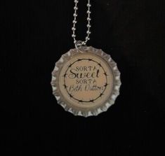 a bottle cap necklace with the words, sorry sweet santa written in black on it