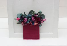 a vase filled with flowers sitting on top of a white door sill next to a wall