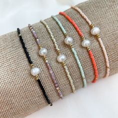 "Add a little Boho Chic to your everyday look with our latest pearl accent beaded bracelets.  Pair them with other bead bracelets, your favorite gold or silver bracelets, or even your watch for the stack of the season. Details:  Miyuki Glass Beads, Freshwater Pearl, Nylon Cord Bracelets expand from 6\" to 10\" A little bit about us: Mom-owned Business Sourcing only the highest quality materials Quick shipping from Colorado" Everyday Beaded Bracelets With Pearl Charm, Everyday Beaded Bracelet With Pearl Charm, Adjustable Pearl Bracelet With Charm And Round Beads, Minimalist Pearl Bracelet With Tiny Round Beads, Adjustable Beaded Pearl Bracelets With Pearl Charm, Adjustable Beaded Pearl Bracelet With Pearl Charm, Dainty Adjustable Beaded Bracelets With Pearl Charm, Dainty Pearl Beaded Bracelets With Spacer Beads, Everyday Pearl Bracelet With Colorful Round Beads