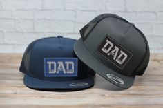 These popular personalized trucker hats have the trendy flat bill and have a snapback. Custom Leatherette Patch with Dad text is adhered to your cap with our industrial hat press. Our Leatherette patches offer the look and feel of genuine leather without using animal products. These richly textured, water resistant patches ensure you will get the quality you expect and are rugged enough to stand up to any adventure. Hat size is one size fits most  * All Patches engrave in Black text EXCEPT the b Customizable Flat Brim Trucker Hat Gift, Customizable Flat Brim Baseball Cap For Gift, Customizable Flat Brim Baseball Cap As Gift, Customizable Flat Brim Baseball Cap Gift, Personalized Casual Snapback Hat With Flat Bill, Letter Print Snapback Trucker Hat For Gift, Letter Print Snapback Trucker Hat As Gift, Letter Print Snapback Trucker Hat, Adjustable Black Trucker Hat For Father's Day