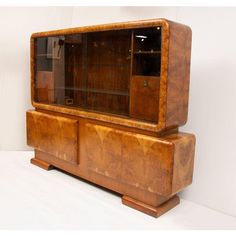 an old fashioned wooden cabinet with glass doors