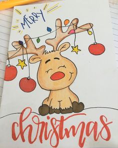 a drawing of a reindeer sitting on top of a notepad with merry christmas written across it