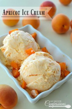 two scoops of apricot ice cream in a white bowl with peaches