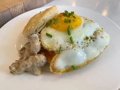 an egg and mushroom sandwich on a white plate