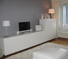 a living room with a large white entertainment center