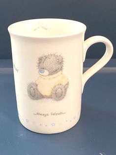 a white coffee cup with a teddy bear on it