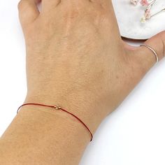 In many cultures, the color red is traditionally used as a symbol of protection, good luck, or blessing. In my native Argentina, red-threaded bracelets are used to ward off evil spirits. The prana bracelets are our modern interpretation of a classic good luck charm. These bracelets are meant to be worn everyday and never take them off until the thread dissolves. They can be worn in the shower. S I Z E S : ∙ Small (Kids 3-8 yrs old): 5"+ 1" extender chain (6" total) ∙ Medium (fits most women): 6" Gold Bracelets With Sliding Knot For Friendship, Gold Sliding Knot Friendship Bracelet, Adjustable Charm Bracelet With Tiny Beads As A Gift, Adjustable Charm Bracelet With Tiny Beads For Gift, Adjustable Tiny Beads Charm Bracelet As A Gift, Gold Friendship Bracelets With Sliding Knot As Gift, Gold Friendship Bracelets With Tiny Beads As Gift, Gold Friendship Bracelet With Sliding Knot As Gift, Adjustable Yellow Gold Bracelets