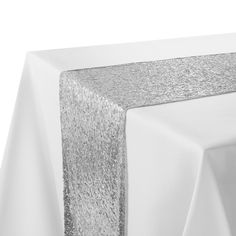 a silver table runner on top of a white table