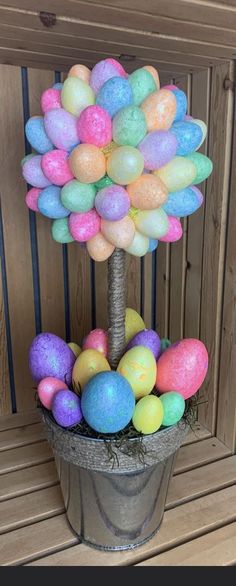 a tree made out of fake eggs in a pot