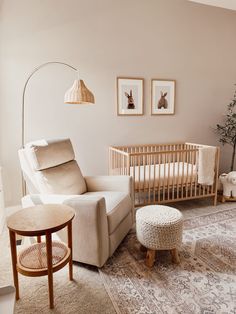 a living room filled with furniture and a baby's crib in the corner