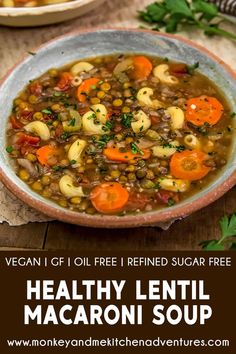 a bowl of healthy lentil macaroni soup with carrots and parsley