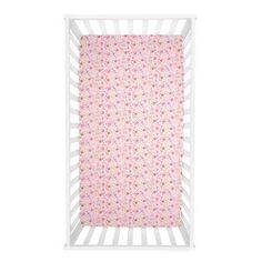 a white crib with pink flowers on it