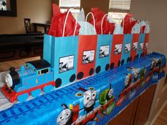 thomas the tank engine birthday party bag set up on a table with red paper bags