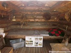 the inside of a log cabin with wooden floors and walls, including an old fashioned bed