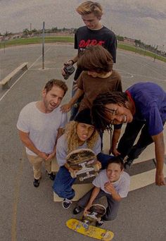 a group of skateboarders posing for a photo