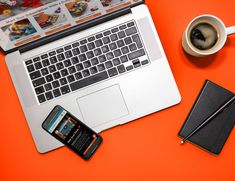 an open laptop computer sitting on top of a desk next to a cup of coffee