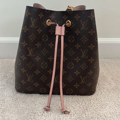 Authentic Louis Vuitton Neonoe Bucket Bag With Baby Pink Detailing! This Beautiful Bucket Bag Has The Ability To Be Converted Into A Crossbody. Like New Condition! Only Used A Few Times. Comes With Dust Bag But Does Not Come With Original Box. Bought At Lv In New York City. Small Stain On Inside Of Bag As Pictured (Haven’t Tried To Get It Out - May Come Out) Inside Is In Great Condition Besides Small Stain. Few Tiny Little Marks On Outside Leather Check Pictures. Free Shipping!!! Louis Vuitton Neonoe, Pink Bag, Authentic Louis Vuitton, Baby Pink, Louis Vuitton Bag, Pink Color, Bucket Bag, York City, New York City