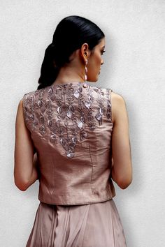 Rose gold embellished jacket with crop top blouse and pants with box pleat panel flare on the top. The Jacket and blouse are made of dupion and the pants are of Georgette with a crepe panel. Delivery Period: 2-3 weeks Elegant Fitted Tops In Raw Silk, Sleeveless Raw Silk Sets For Party, Elegant Fitted Sets With Padded Blouse, Elegant Raw Silk Party Tops, Glamorous Fitted Silk Set, Formal Fitted Sets With Padded Blouse, Party Raw Silk Padded Blouse, Formal Fitted Set With Padded Blouse, Chic Embellished Silk Set