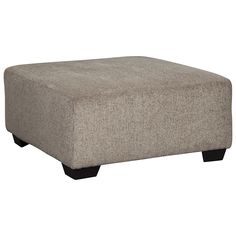 a grey ottoman sitting on top of a white floor