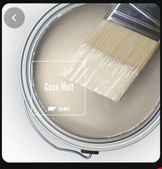 a paint can with a brush in it and the words coco mat on top of it