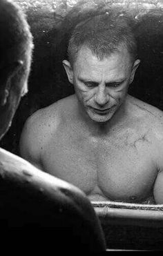 a man in the bathtub looking at his reflection