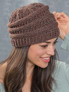 a woman wearing a brown knitted hat