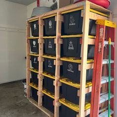 several bins stacked on top of each other in a storage room with ladders