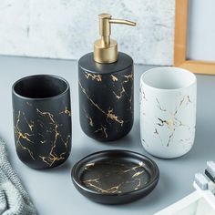 black and gold bathroom accessories on a table