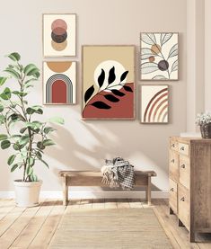 a living room filled with furniture and paintings on the wall next to a potted plant