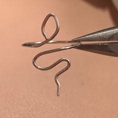 a pair of scissors cutting through some metal wire