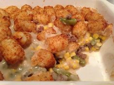 a casserole dish with tater tots and corn