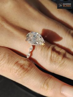 a woman's hand with a diamond ring on it