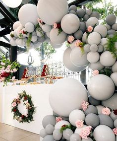 an instagram with balloons and flowers hanging from the ceiling