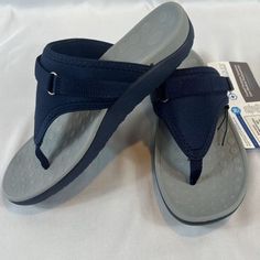 Introducing The Medical Soles Flip Flop Sporty Neoprene Orthotic Adjustable Thong Sandal In Navy! This Versatile Sandal Is Perfect For Any Casual Occasion And Features A Solid Pattern In Black, An Adjustable Strap For A Comfortable Fit, And A Slip-On Closure For Easy Wear. Crafted With Neoprene Upper Material And A Rubber Outsole, This Sandal Is Lightweight, Breathable, And Provides Arch Support For Maximum Comfort. It Also Boasts Orthopedic Features And Is Adjustable, Making It The Ideal Choice Gray Slip-on Flip Flops For The Beach, Blue Toe Post Sandals With Arch Support, Adjustable Blue Flip Flops With Arch Support, Adjustable Blue Flip Flops With Textured Footbed, Beach Gray Cushioned Flip Flops, Blue Outdoor Flip Flops With Arch Support, Comfortable Blue Flip Flops With Arch Support, Blue Flip Flops With Arch Support And Round Toe, Tory Burch Slides