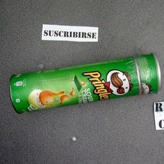 a tube of gum sitting on top of a table next to a sticker that says suscribuse