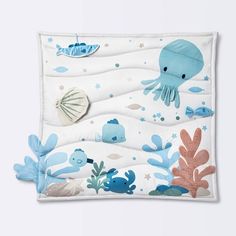 an ocean themed placemat with blue and white sea animals on it, under the water