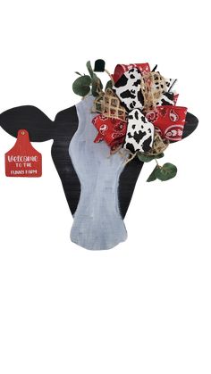 a cow head with red and white flowers in it