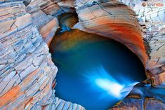 the water is blue in color and it looks like something out of a fairy land