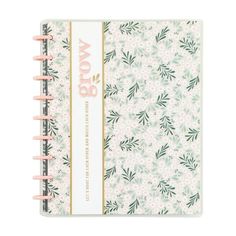 a notebook with flowers and the word wow on it, in front of a white background