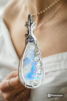 What a beautiful Moonstone!    great blue/purple flashes with so much depth and interesting inclusions. Also accented with an Amethyst in the middle. It's hand wrapped in sterling silver  and hand polished to a brilliant shine. It comes hanging from a 20"  stainless steel chain, so you can wear right away. Unique Silver Crystals With Natural Stones, Handmade Silver Crystals For Jewelry Making, Handmade Silver Crystal Pendant, Elegant Hand-wrapped Moonstone Jewelry, Silver Wire Wrapped Crystals For Jewelry Making, Wire Wrapped Silver Crystals For Healing, Handmade Silver Amethyst Crystals, Wire Wrapped Silver Crystals For Spiritual Use, Mystical Silver Gemstone Crystals