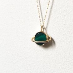 This sweet pendant is made using a saturn setting that I handmade and had cast in brass, which is then plated in shiny 14k gold. A beautiful  banded green malachite is set in the center, and it hangs on an 18" 14k gold-filled chain. Perfect for that space loving gal. Also available with a lapis, abalone, opal/turquoise/copper mash up, moonstone, or turquoise. Tarnish Resistant Gold-plated Green Jewelry, Tarnish Resistant Green Gold-plated Jewelry, Tarnish-resistant Gold-plated Green Jewelry, Handmade 14k Gold Round Pendant Jewelry, Tarnish Resistant Green Round Jewelry, Green Tarnish Resistant Round Jewelry, Green Recycled Gold Jewelry For May Birthstone, Oval Malachite Jewelry In Yellow Gold, Handmade 14k Gold-filled Round Necklaces