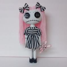 a doll with pink hair and big eyes